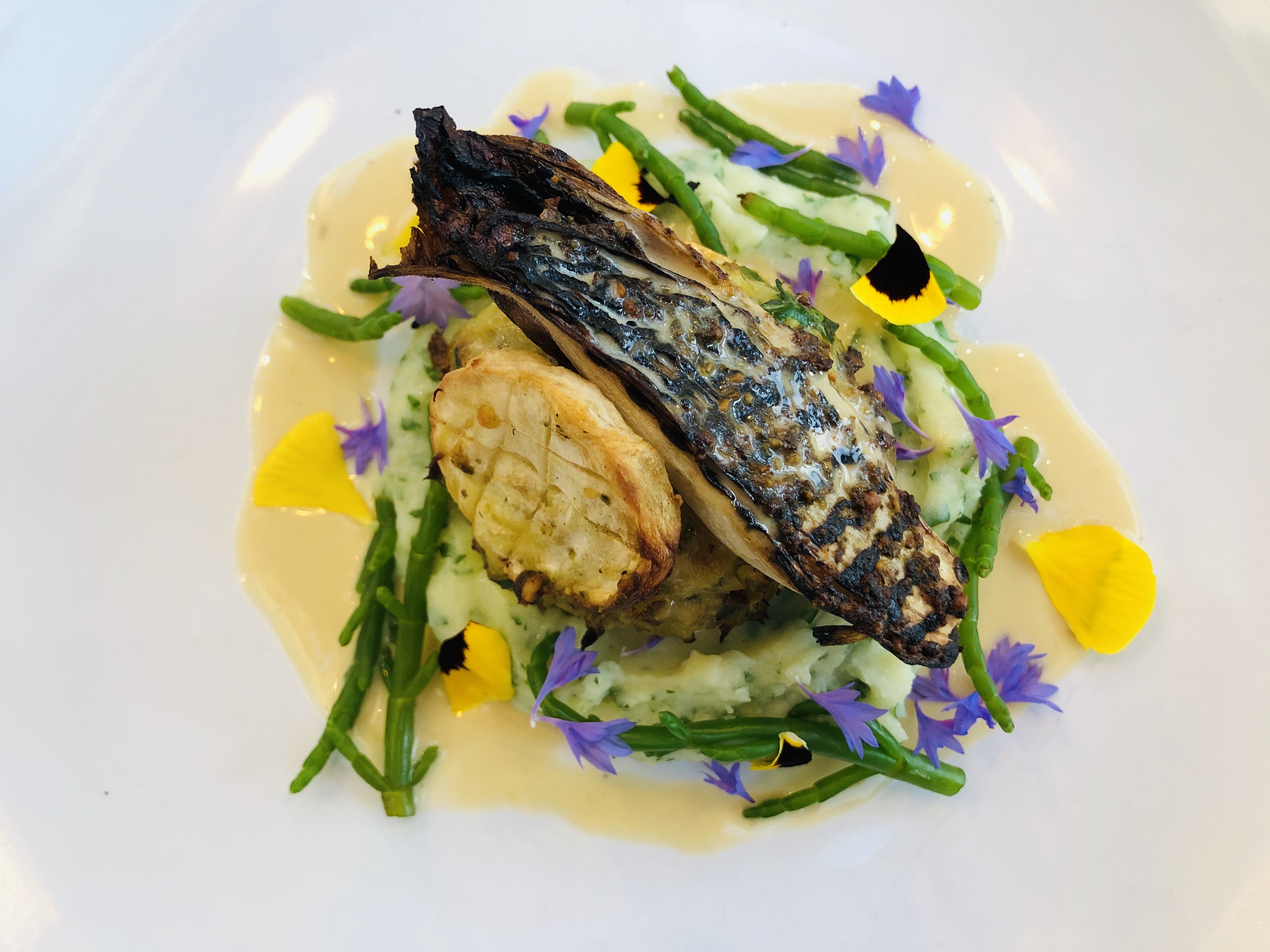 Dish featuring samphire and edible flowers