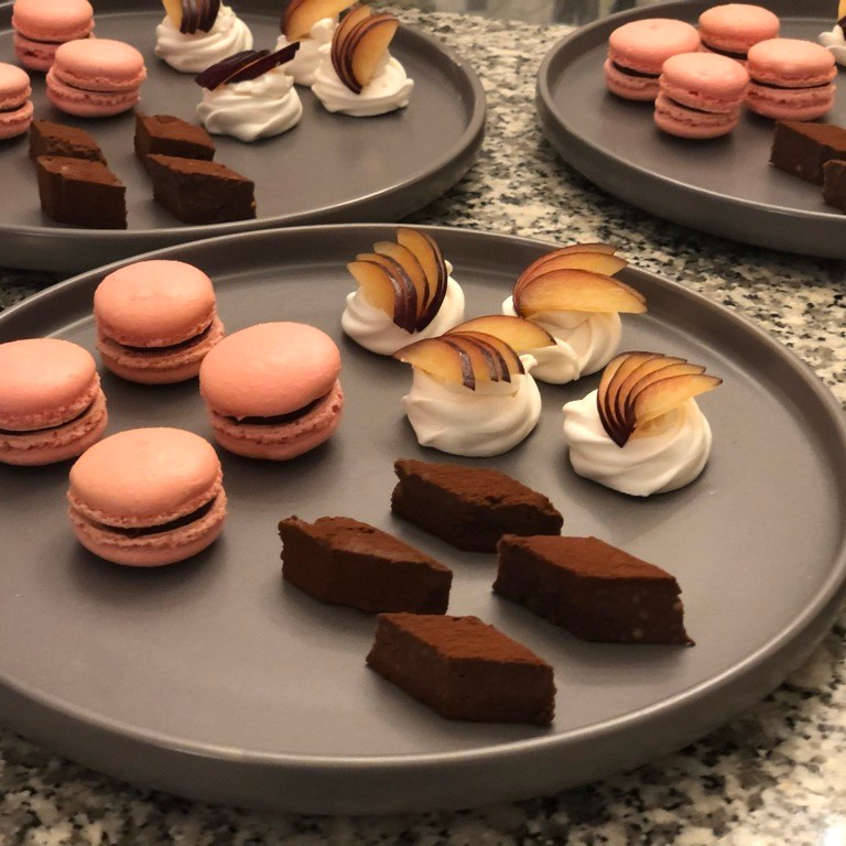 plated party sharing desserts and macarons
